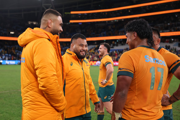 Taniela Tupou (centre) and teammates celebrate Australia’s win over Wales on Saturday night. 