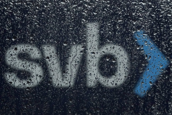 A sign to Silicon Valley Bank is seen through raindrops on a window in Santa Clara, California.
