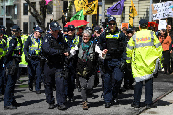 An Extinction Rebellion activist is arrested during a protest in Melbourne on Tuesday.