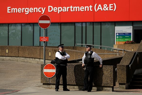 Police officers stand outside St Thomas' Hospital, where Prime Minister Boris Johnson remains in intensive care.