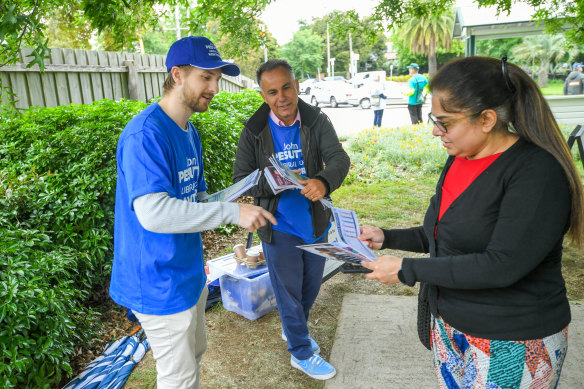 John Pesutto (centre) handing out at the Camberwell pre-polling centre.