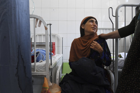 Tahera, 40, is comforted moments after her three-month-old son Safiullah died from severe acute malnutrition.