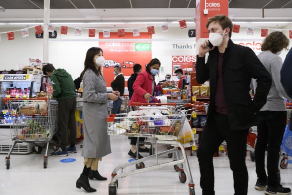 Supermarket staff have had to ensure customers are wearing masks and have also borne the brunt of several rounds of panic buying, as seen here in Sydney in June.