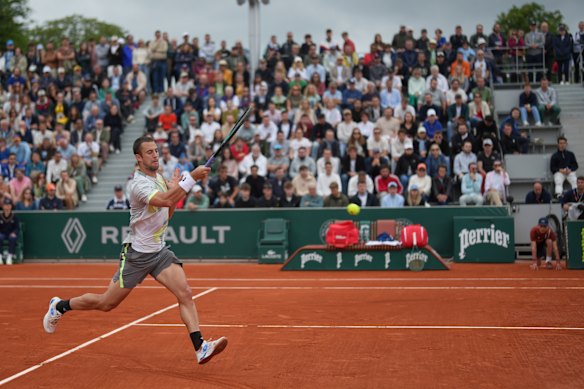 Serbia’s Laslo Djere hits a forehand against Alex De Minaur.