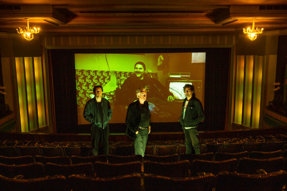 Haydn Green, Mick Harvey and Gareth Liddiard, with Eric Bana as Chopper Read looming in the background, at the Astor.