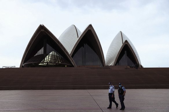 Police patrol lockdown rules outside the Sydney Opera House.