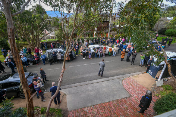 A large crowd gathered to watch Saturday’s auction of the Ringwood East home.