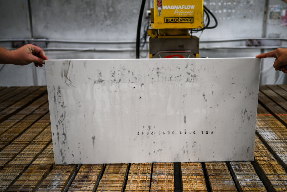 Engineered stone being water cut in a factory.