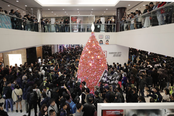 Protesters march through a mall on Christmas Eve in Hong Kong.