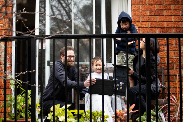 Lockdown lesson ... Justine Toh and Vaughan Olliffe are home-schooling their children, Caleb, 5, left, and Rhys, 7, in their small Sydney apartment.