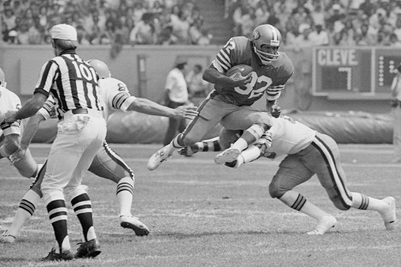 San Francisco 49er O.J. Simpson takes to the air as Cleveland Brown’s Thom Darden makes the tackle during an NFL game on September 3, 1978.