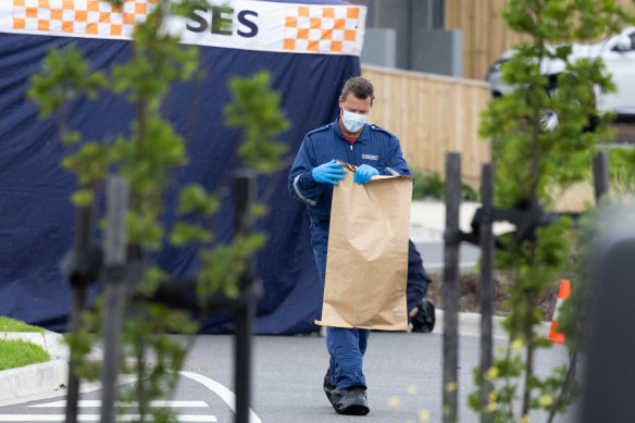 A forensic officer bags up evidence at the Donnybrook home.