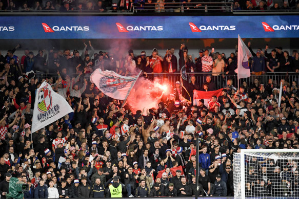 Sydney United fans light a flare during the Australia Cup match between Sydney United FC and Macarthur FC at CommBank Stadium. 