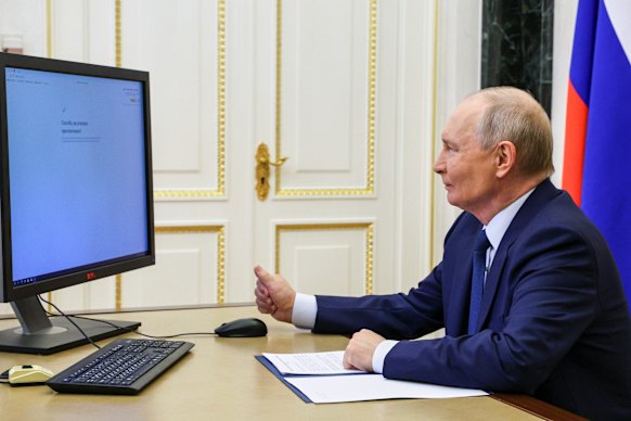 Russian President Vladimir Putin votes online at the Kremlin on Friday.