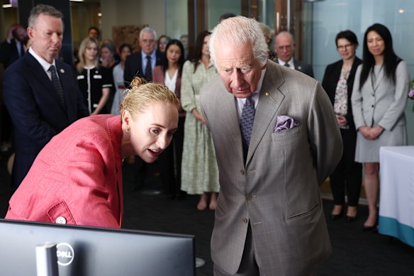 Britain’s King Charles is briefed by co-medical director Georgina Long as he visits the Melanoma Institute of Australia in Sydney in 2024.
