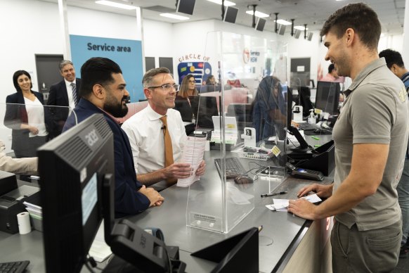 Premier Dominic Perrottet serves customers at Service NSW in Parramatta. 