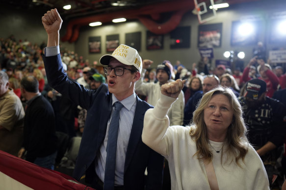 Supporters cheer before the arrival of former president Donald Trump at a rally in Iowa.