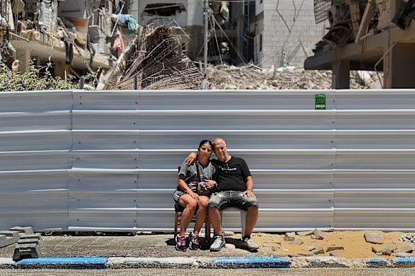 Ronen Sha’a Shua (right) and his partner Ivanka (left) in front of their home. They are waiting to gain access to after it was destroyed in an Iranian ballistic missile strike on June 15.