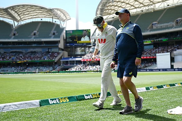 Nathan Lyon limps off the Adelaide Oval after injuring his hamstring.