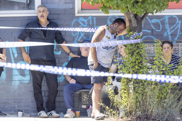 More mourners keep watch over the crime scene.