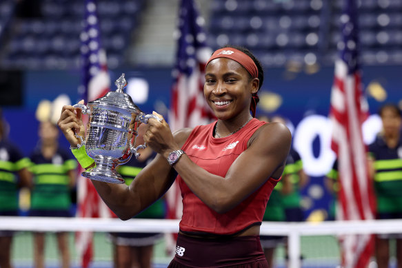 Coco Gauff celebrates with the US Open trophy.