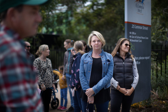 Kasey Thompson (centre) and other parents outside Richmond West Primary School, where tensions have spiked over the nearby safe injecting room.