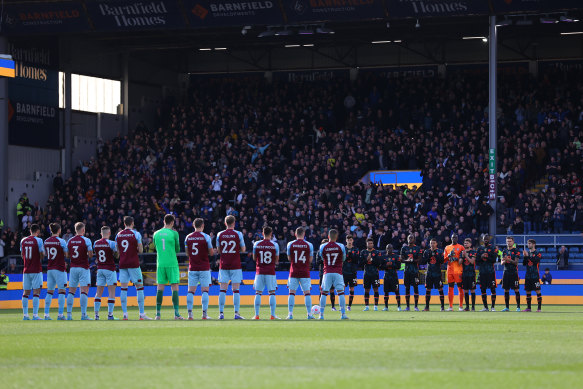Players, fans and officials take part in the minute’s applause before Chelsea’s clash with Burnley.