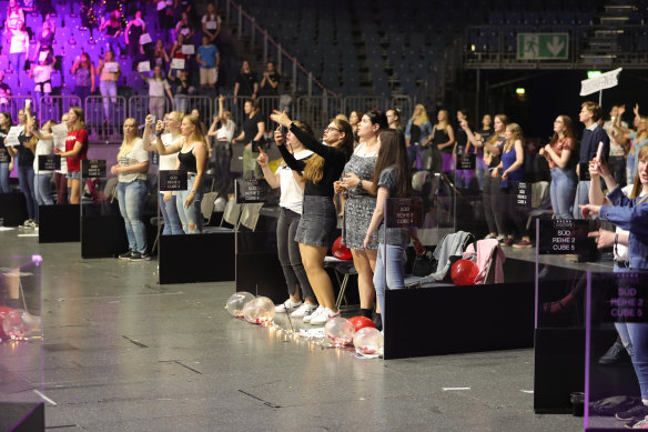 Germans attend a live concert in Cologne, Germany under social distancing restrictions. The hall has been equipped with plexiglas boxes, installed 2-3 meters apart from one another, and up to four people are allowed in each box.
