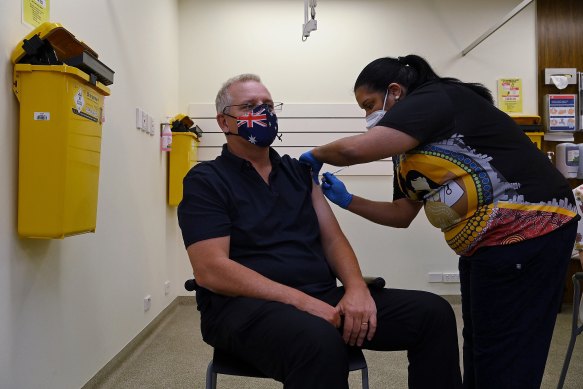 Prime Minister Scott Morrison (left) receiving his COVID-19 booster vaccination administered by Aboriginal Health Practitioner Hannah Moore (right) at Kildare Road Medical Centre in Blacktown in Sydney.