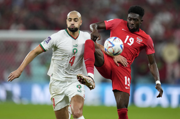 Morocco’s Sofyan Amrabat and Canada’s Alphonso Davies. 