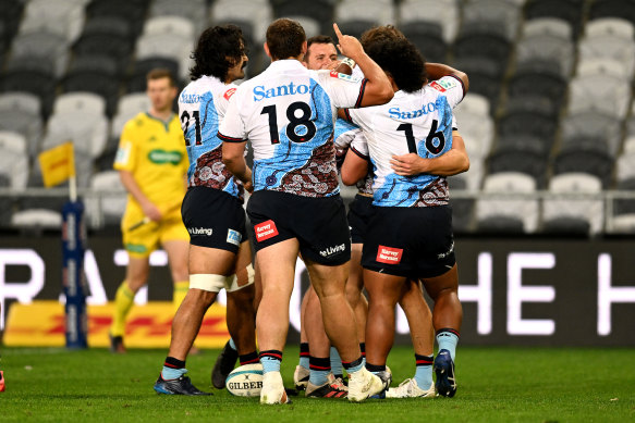 The Waratahs celebrate Tane Edmed’s try in Dunedin.