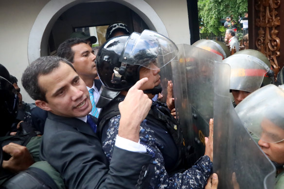 Guaido eventually forced his way past the riot shields of the troops and into parliament.