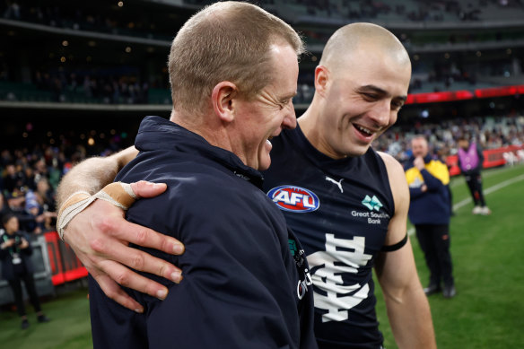 Michael Voss, senior coach of the Blues and Alex Cincotta celebrate their win. 