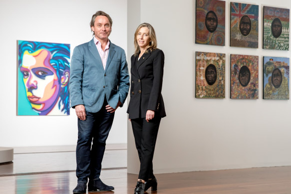 Tony Ellwood, director of the NGV, and Karen Quinlan, director of the  National Portrait Gallery, in front of Howard Arkley’s portrait of Nick Cave, and, to the right, Julie Dowling’s Federation Series 1901-2001.