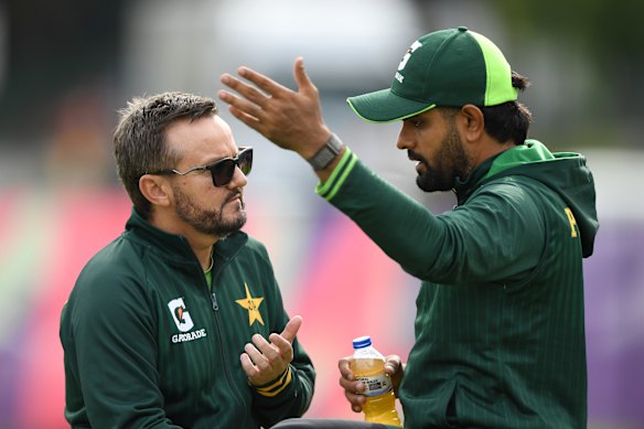 Pakistan’s white ball head coach Mike Hesson speaking with Babar Azam.