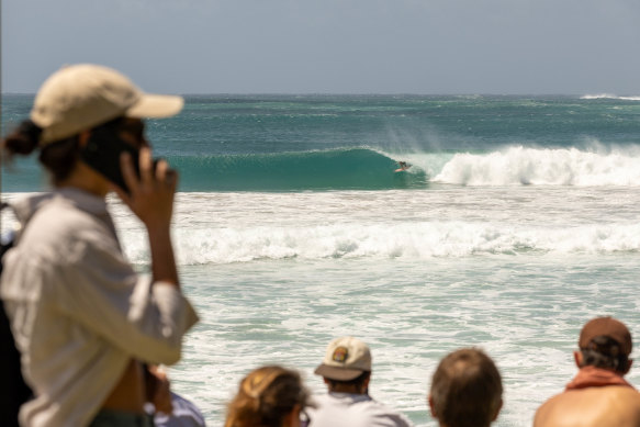 Byron Bay beachgoers take in the big swell caused by Cyclone Alfred.