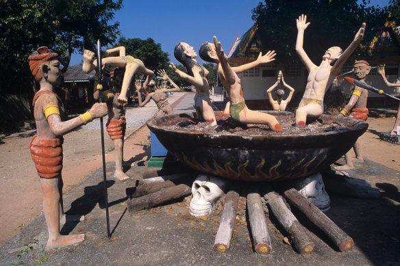 Sinners burn in a cauldron in Buddhist hell in Wat Wang Saen Suk Hell Garden, Bangkok.
