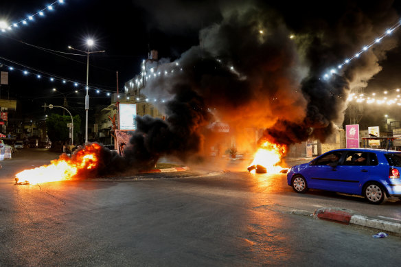 Tyres set alight burn on a street after a Palestinian was killed during an Israeli military operation in Jenin, in the Israeli-occupied West Bank, on Monday.