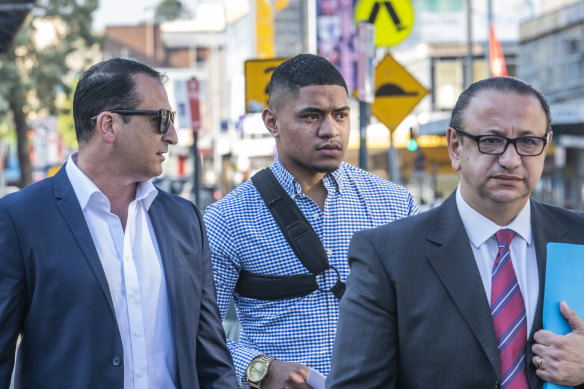 Manase Fainu (centre) arriving at Liverpool police station at the start of his legal battle in October, 2019.