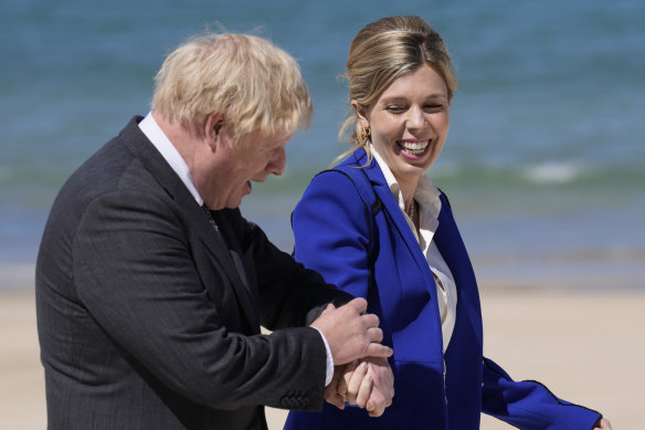British Prime Minister Boris Johnson and his wife Carrie walk on the boardwalk during G7 on June 12 in St Ives, England.  In a post on Instagram, Carrie Johnson has said she feels “incredibly blessed to be pregnant again”, expecting the couple’s second child. 