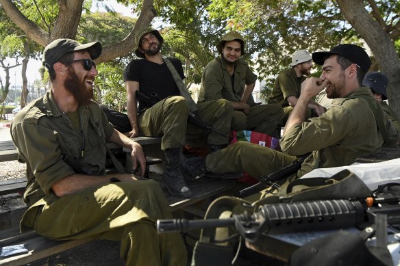 Israel Defence Forces reservists with Adam Lavie’s tank unit have a day of recreation in Tel Aviv before deployment.