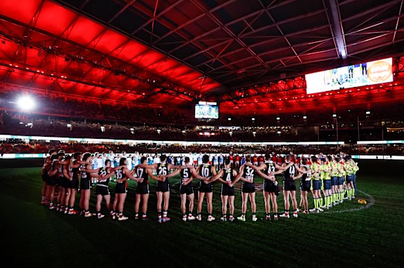 St Kilda Saints and the Brisbane Lions players huddle before Spud’s game in 2023.