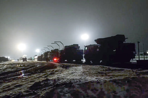 Russian military vehicles prepare to drive off a railway platform after arrival in Belarus in January.