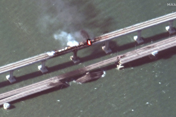 This satellite image provided by Maxar Technologies shows damage to the Kerch Bridge, which connects the Crimean Peninsula with Russia crossing a strait between the Black Sea and the Sea of Azov.