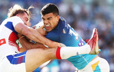The Knights’ Connor Watson struggles to contain a rampaging David Fifita.
