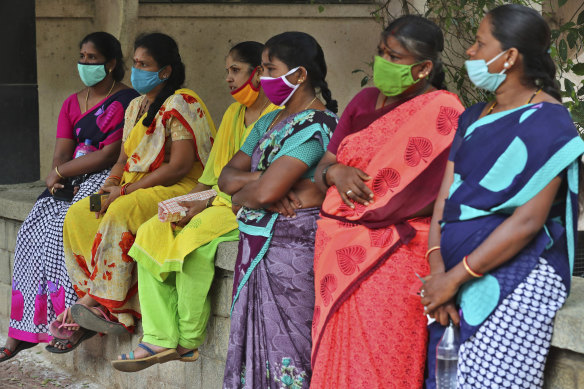 Domestic workers listen during a protest demanding social security from the government in Bengaluru, India.