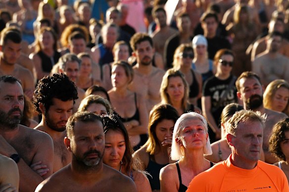 Hundreds of people listen to speeches before Friday’s paddle-out at Bondi Beach to pay tribute to the victims of the massacre last Sunday. 