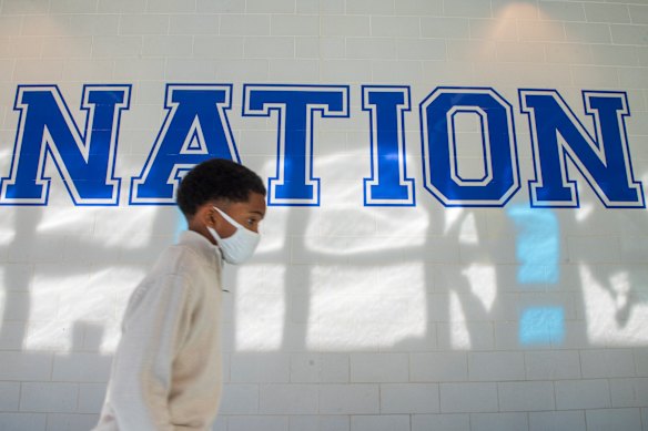A young boy walks down a hallway to get tested for COVID-19 at a high school in the Algiers neighbourhood of New Orleans on Monday.
