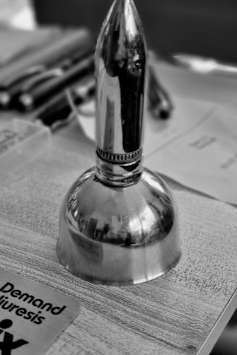 Ginsberg kept the larger shell casing and a smaller bullet that were shot at him and, with a domed piece that was used for hip reconstructions, he created a bell. 