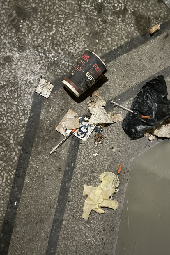 Rubbish and used needles litter the ground of an empty building in a laneway behind Elizabeth Street.